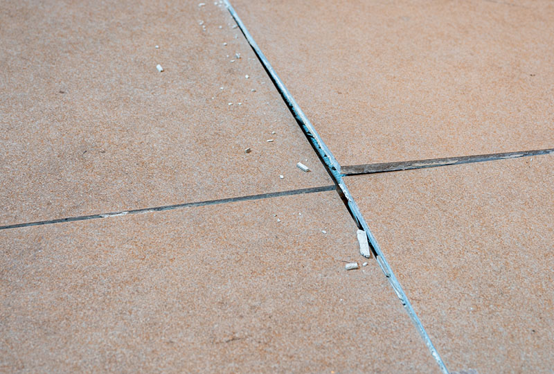 A close-up of ceramic tiles with clearly visible tile-lippage